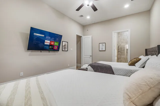 a bedroom with a bed and a flat screen tv