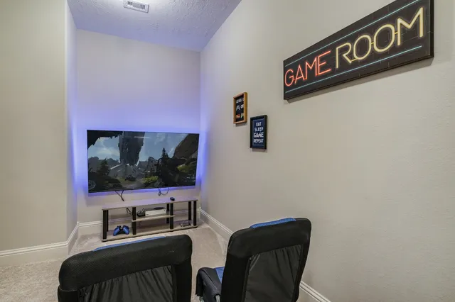 a room with furniture and flat screen tv