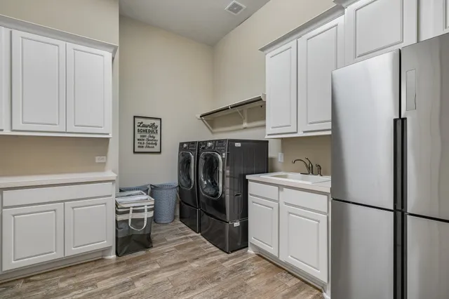 a kitchen with stainless steel appliances a refrigerator sink and cabinets