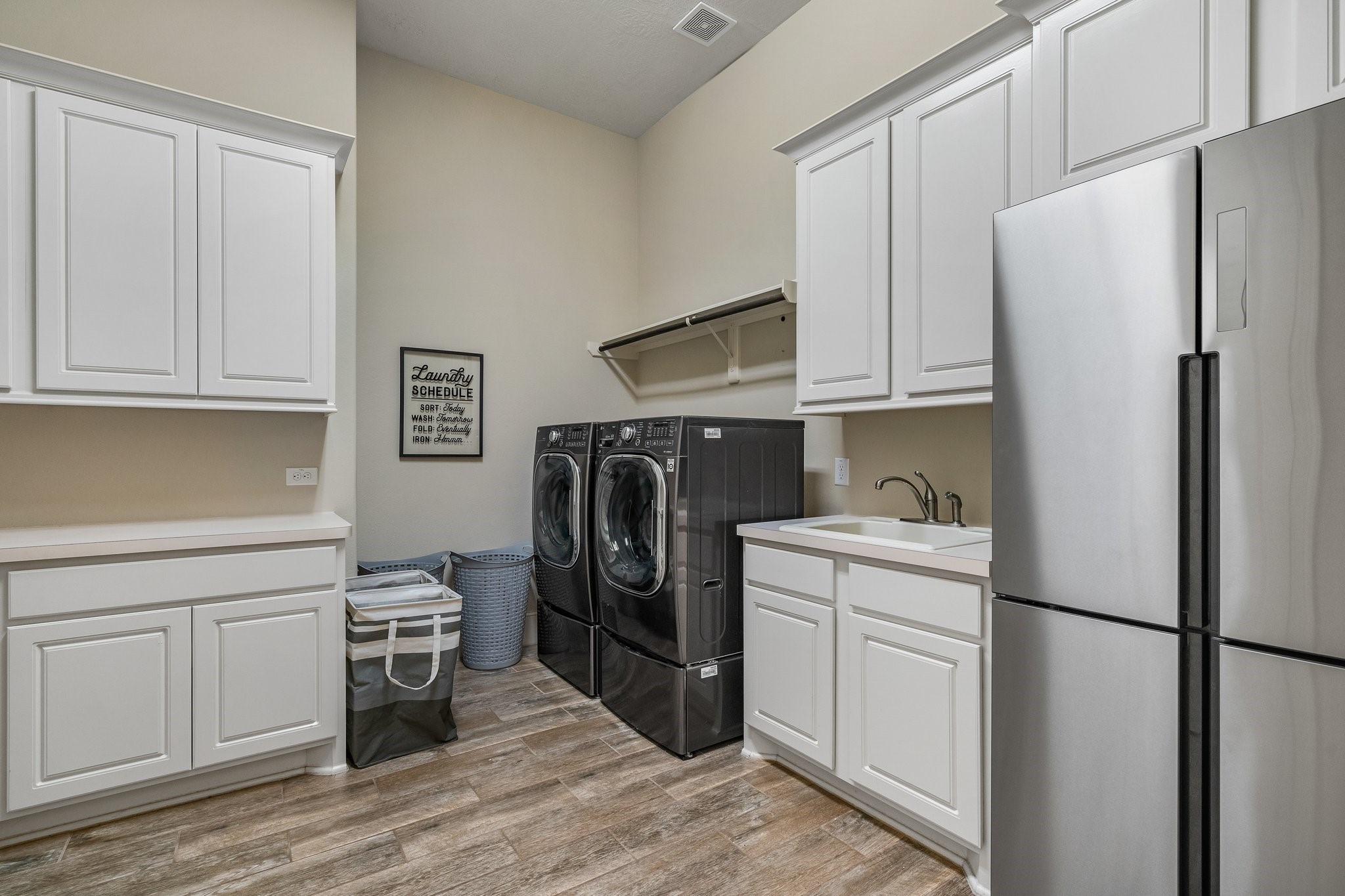 27411 Hazy Landing Court Spring, TX 77386 - Photo 43 of 50 a kitchen with stainless steel appliances a refrigerator sink and cabinets