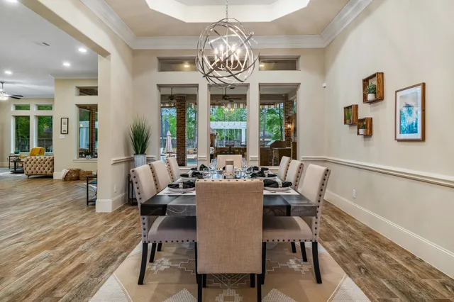 a view of a dining room with furniture wooden floor and chandelier