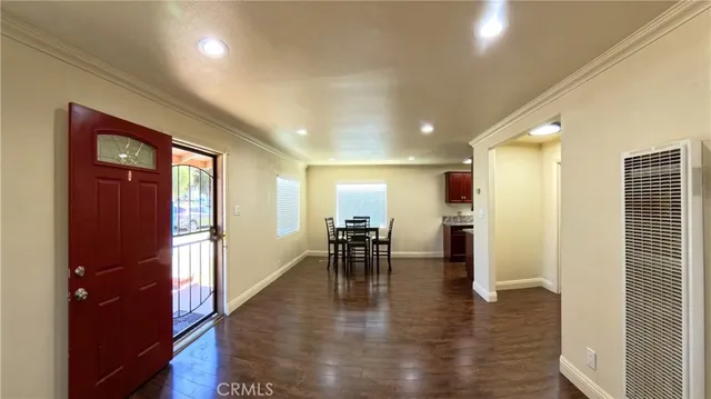 an open dining room with furniture and wooden floor