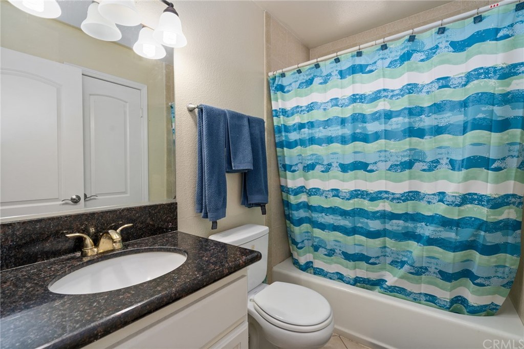 2925 East Spaulding Street, Unit 307 Long Beach, CA 90804 - Photo 12 of 18 a bathroom with a sink toilet and shower