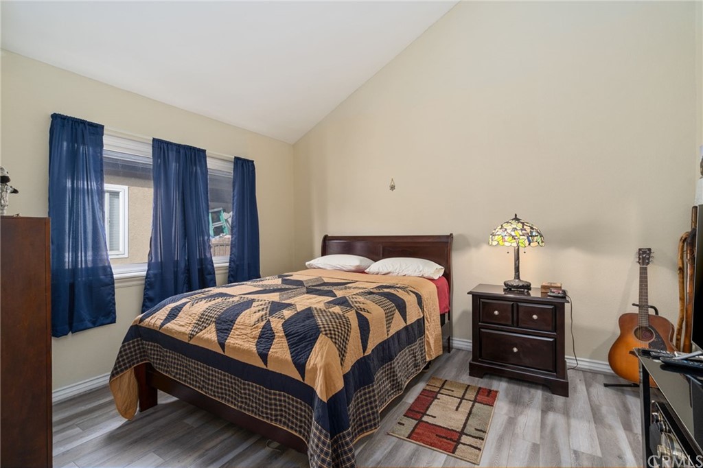 2925 East Spaulding Street, Unit 307 Long Beach, CA 90804 - Photo 13 of 18 a bedroom with a bed and wooden floor
