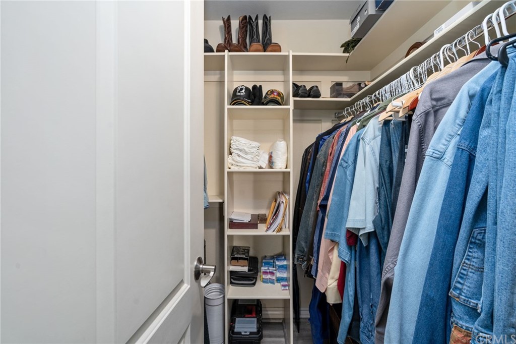 2925 East Spaulding Street, Unit 307 Long Beach, CA 90804 - Photo 16 of 18 a view of walk in closet with clothes and shoes