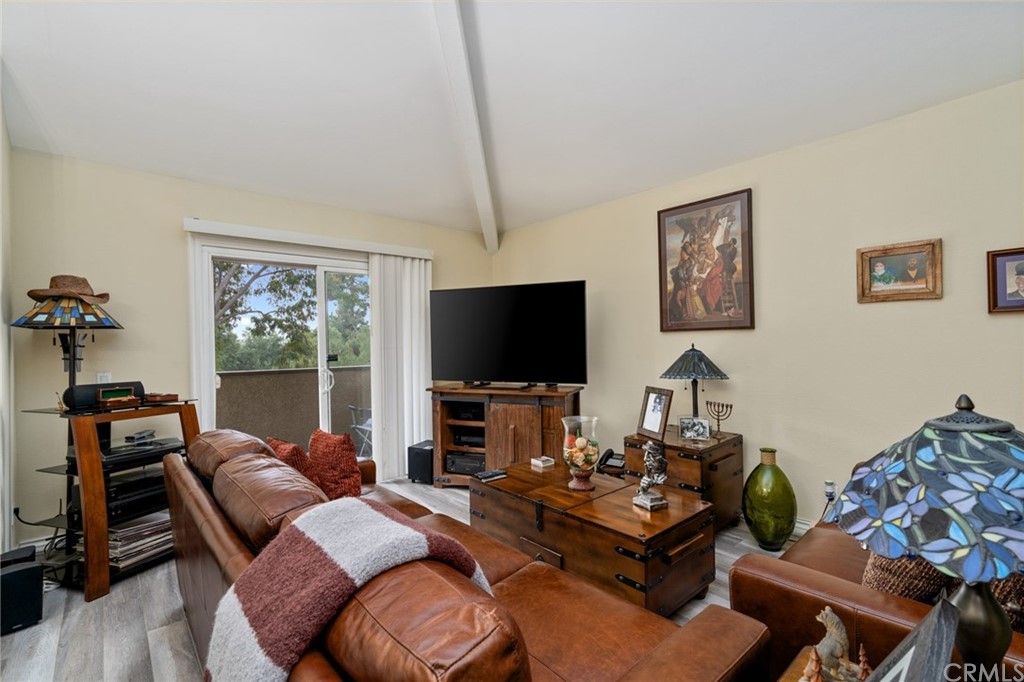 2925 East Spaulding Street, Unit 307 Long Beach, CA 90804 - Photo 5 of 18 a living room with furniture and a flat screen tv