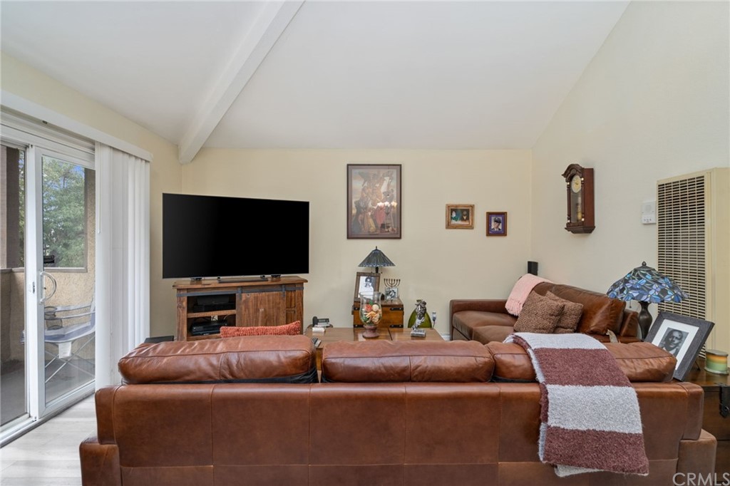 2925 East Spaulding Street, Unit 307 Long Beach, CA 90804 - Photo 6 of 18 a living room with furniture and a flat screen tv