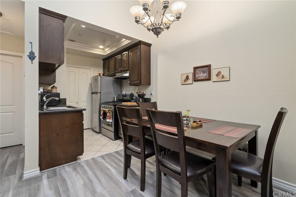 2925 East Spaulding Street, Unit 307 Long Beach, CA 90804 - Photo 7 of 18 a view of a dining room with furniture and wooden floor