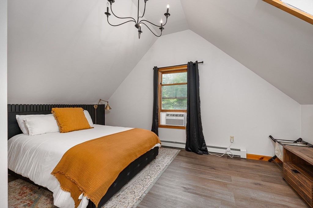 124 East Hawley Road Hawley, MA 01339 - Photo 18 of 39 a bedroom with a bed and wooden floor