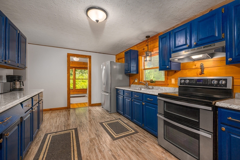 124 East Hawley Road Hawley, MA 01339 - Photo 3 of 39 a kitchen with granite countertop wooden cabinets and stainless steel appliances