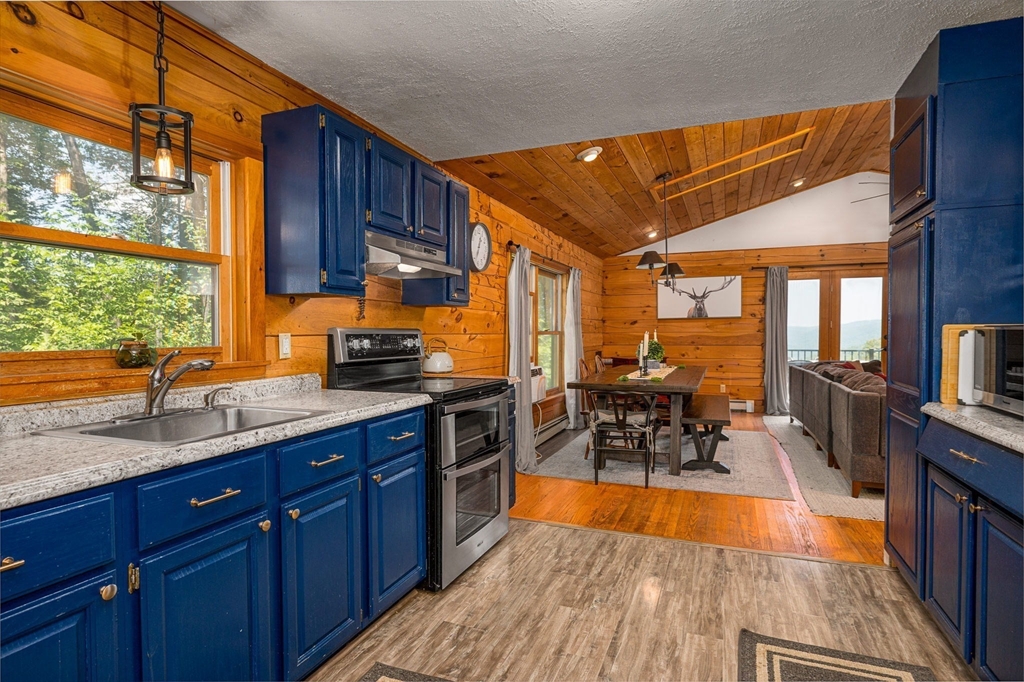 124 East Hawley Road Hawley, MA 01339 - Photo 4 of 39 a kitchen with stainless steel appliances granite countertop sink stove next to a window