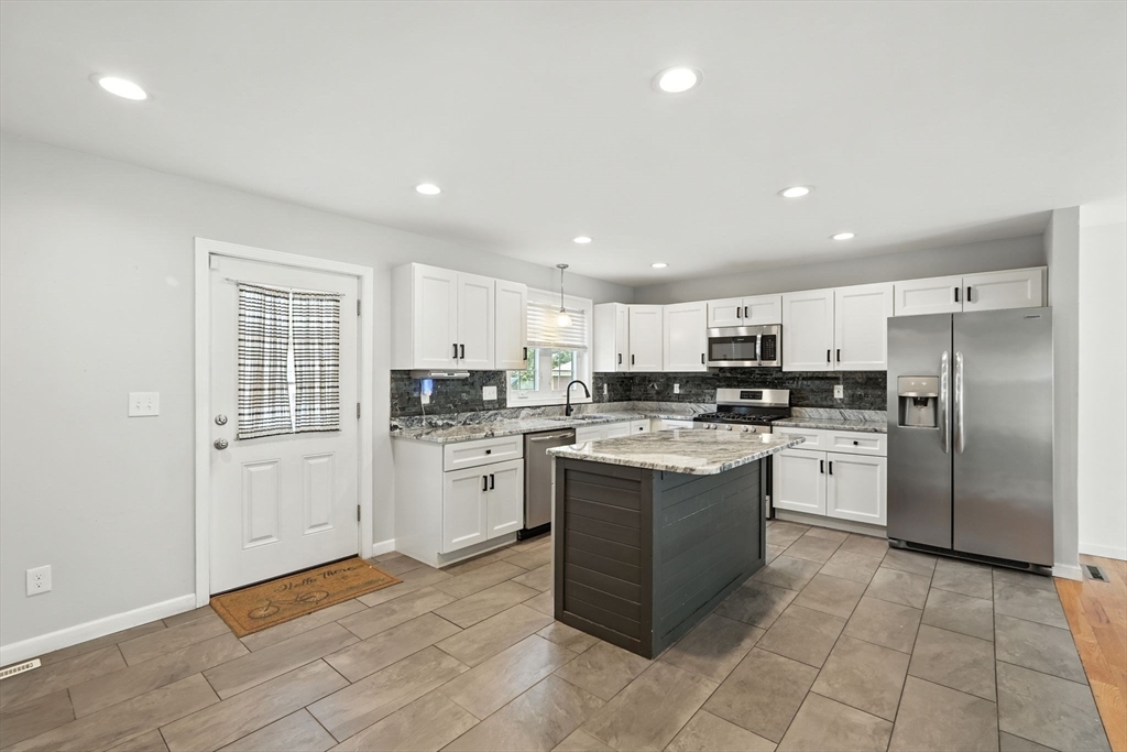 24 Porter Street Springfield, MA 01104 - Photo 12 of 42 a kitchen with a refrigerator and cabinets