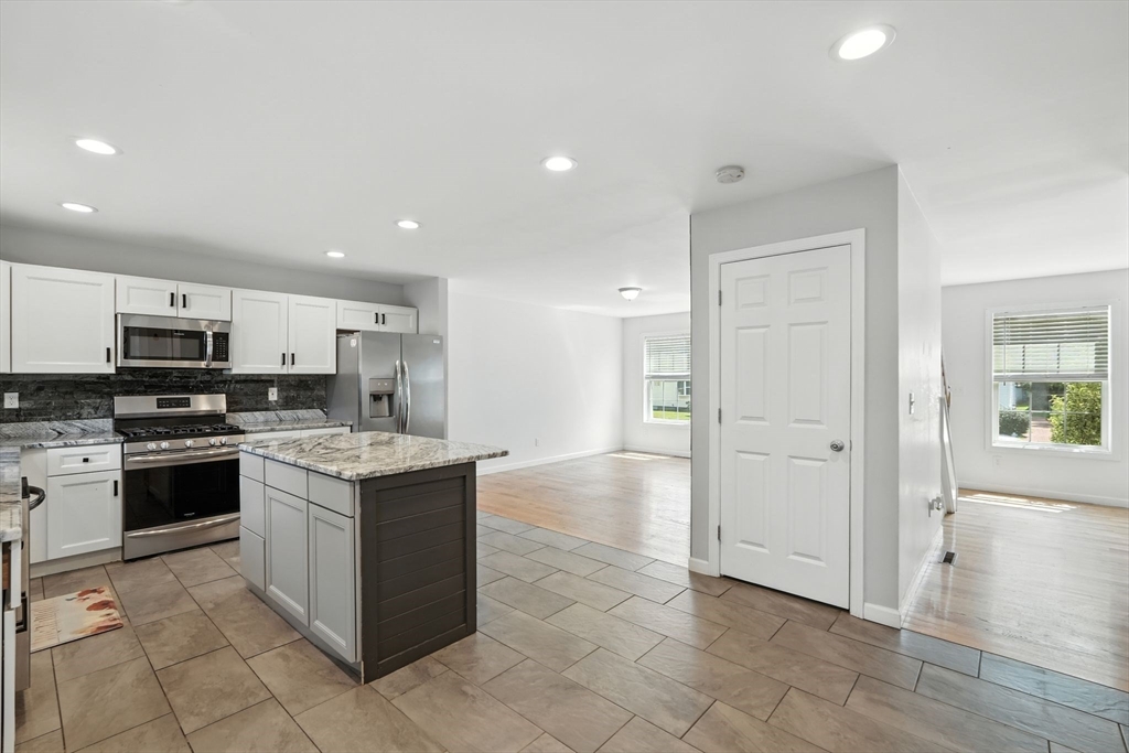 24 Porter Street Springfield, MA 01104 - Photo 13 of 42 a kitchen with stainless steel appliances granite countertop a refrigerator and a stove top oven