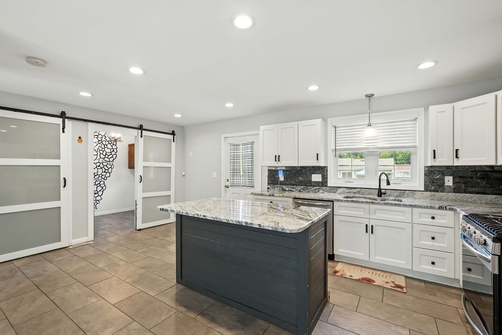 24 Porter Street Springfield, MA 01104 - Photo 15 of 42 a large kitchen with stainless steel appliances granite countertop a sink and cabinets