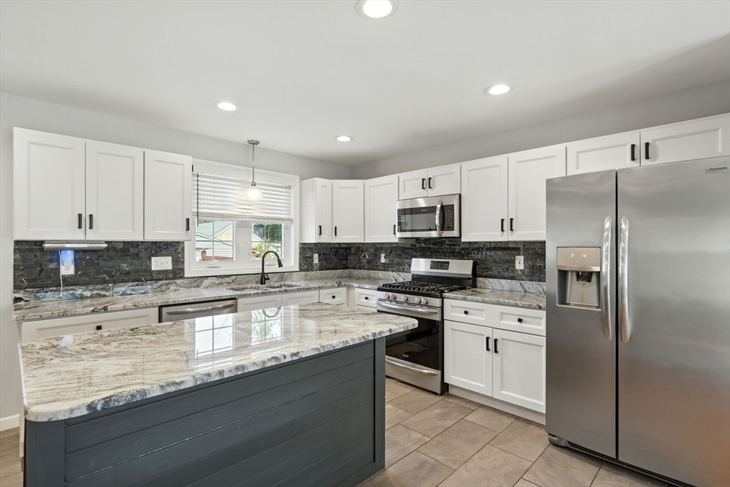 24 Porter Street Springfield, MA 01104 - Photo 16 of 42 a kitchen with stainless steel appliances granite countertop a refrigerator sink and white cabinets