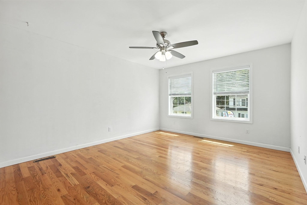 24 Porter Street Springfield, MA 01104 - Photo 22 of 42 a view of empty room with wooden floor and fan