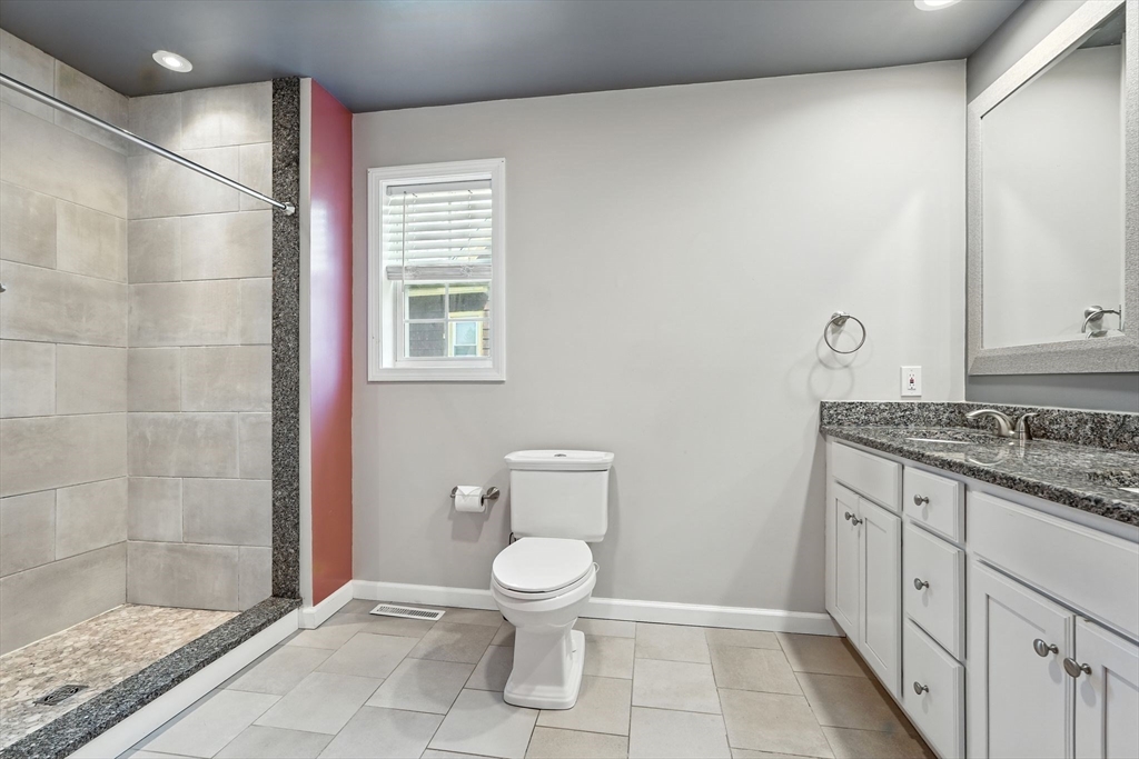 24 Porter Street Springfield, MA 01104 - Photo 26 of 42 a bathroom with a granite countertop sink a toilet and a shower