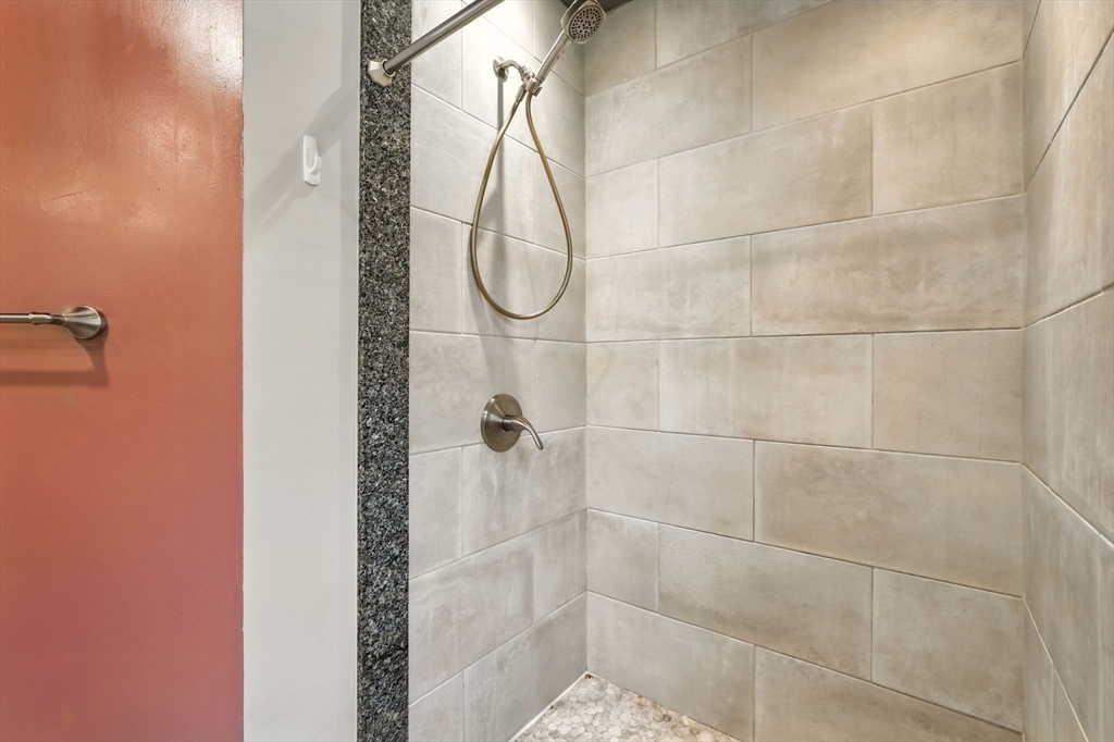 24 Porter Street Springfield, MA 01104 - Photo 27 of 42 a bathroom with a glass shower door