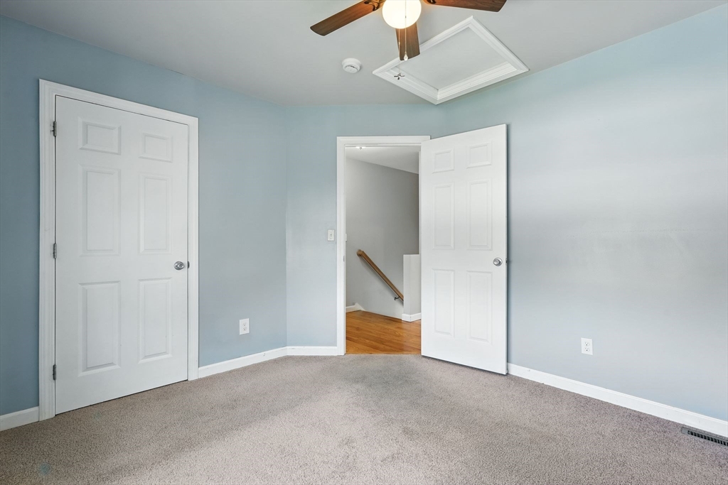 24 Porter Street Springfield, MA 01104 - Photo 29 of 42 an empty room with chandelier fan and closet area