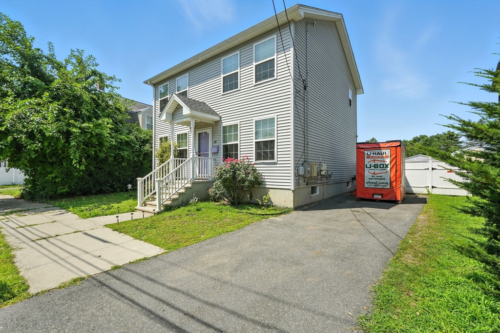 24 Porter Street Springfield, MA 01104 - Photo 3 of 42 a front view of a house with a yard and garage