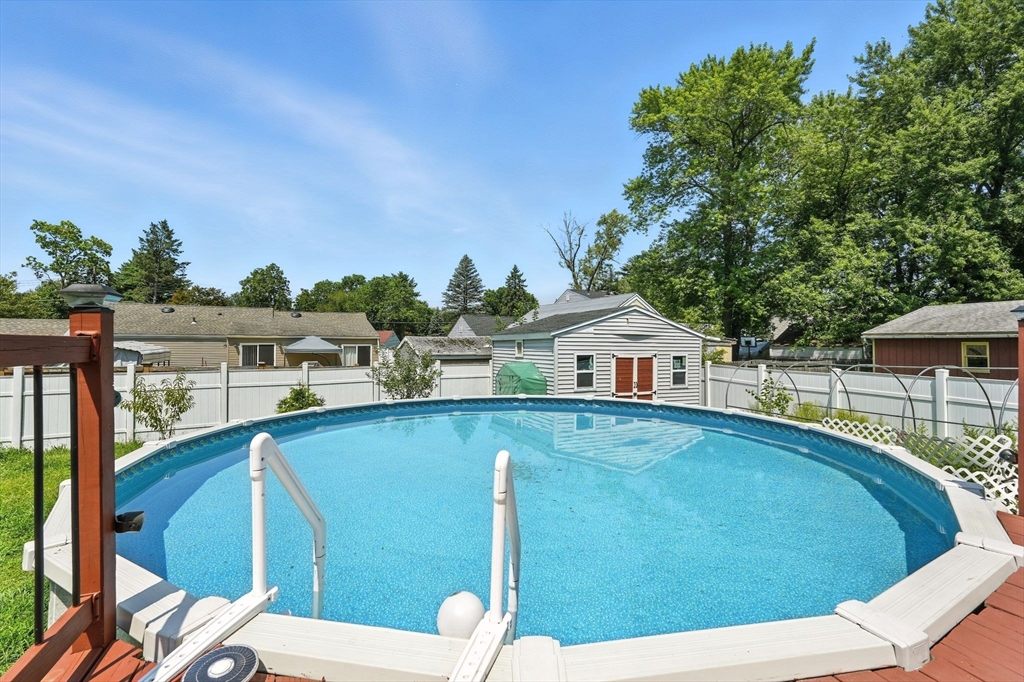 24 Porter Street Springfield, MA 01104 - Photo 4 of 42 a view of a patio with table and chairs potted plants with wooden floor and fence