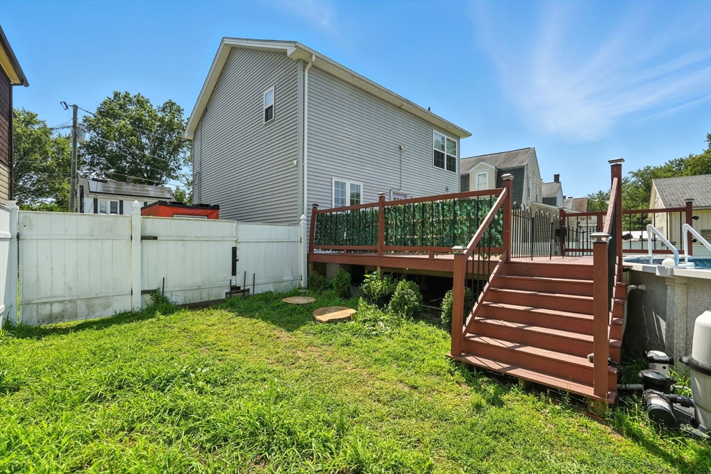 24 Porter Street Springfield, MA 01104 - Photo 41 of 42 a view of a backyard with chairs and wooden fence