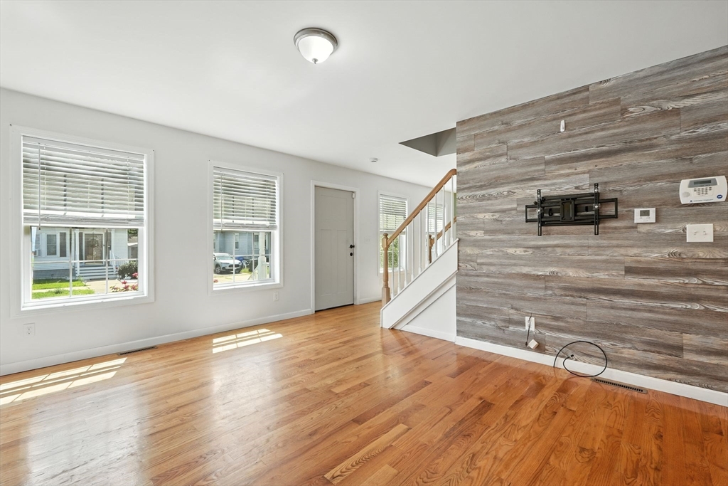 24 Porter Street Springfield, MA 01104 - Photo 9 of 42 a view of an empty room with wooden floor and a window
