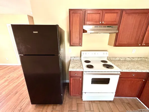 a white refrigerator freezer sitting inside of a kitchen