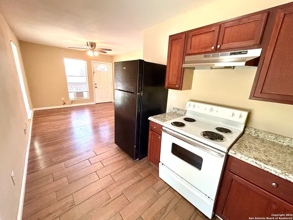 a kitchen with a refrigerator sink and stove