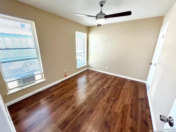 wooden floor in an empty room with a window
