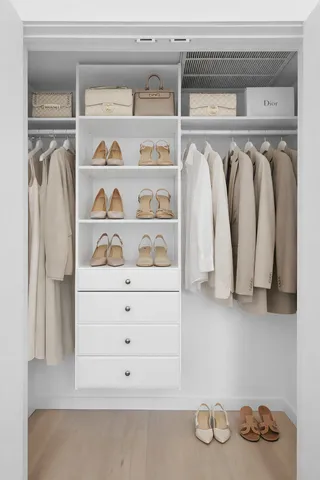 a bedroom with a bed and painting on the wall