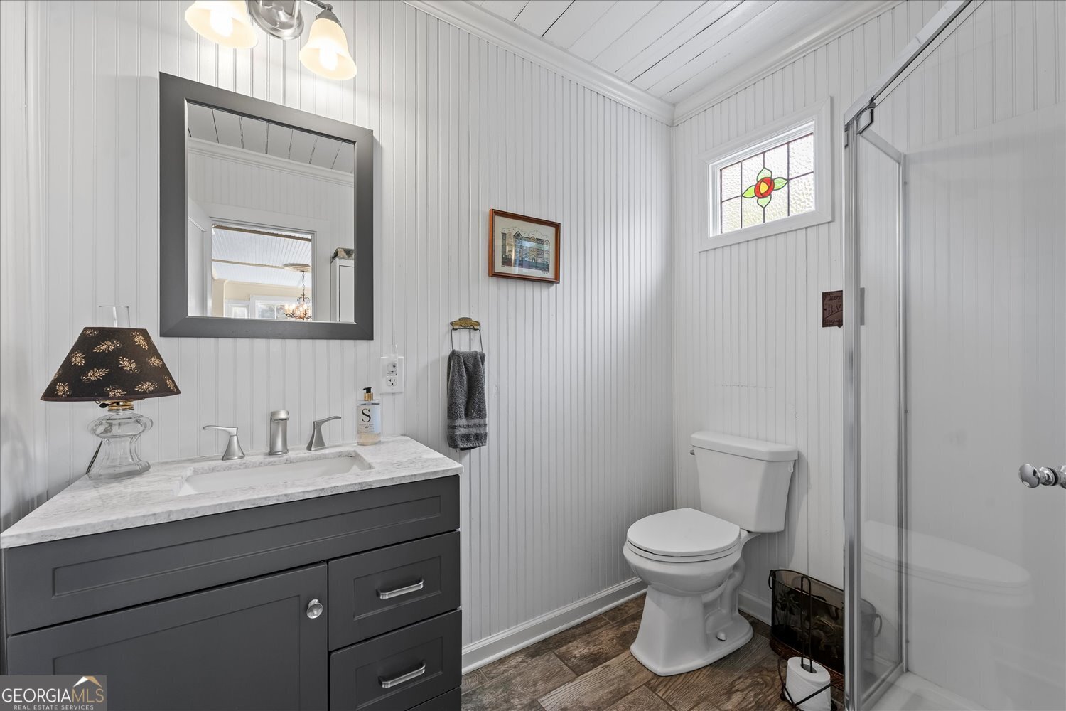 6644 East Cadley Road Norwood, GA 30821 - Photo 29 of 53 a bathroom with a toilet sink and mirror