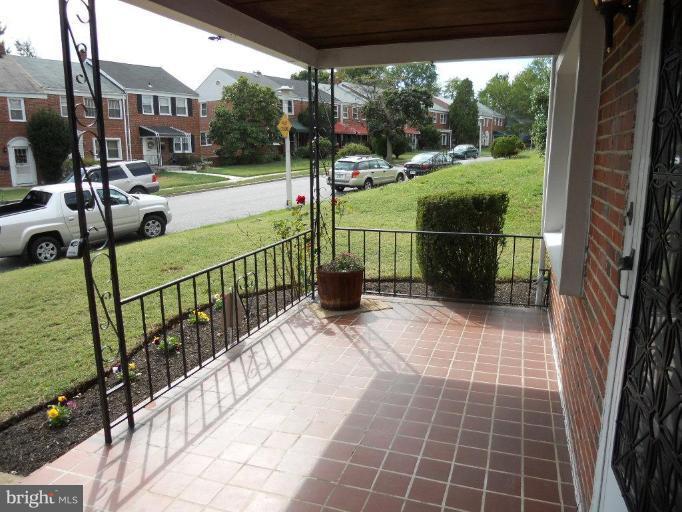 844 Bradhurst Road Baltimore, MD 21212 - Photo 2 of 17 a view of a porch with wooden floor and yard
