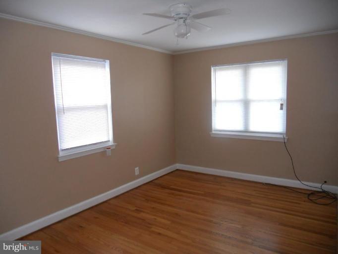 844 Bradhurst Road Baltimore, MD 21212 - Photo 17 of 17 wooden floor in an empty room with a window