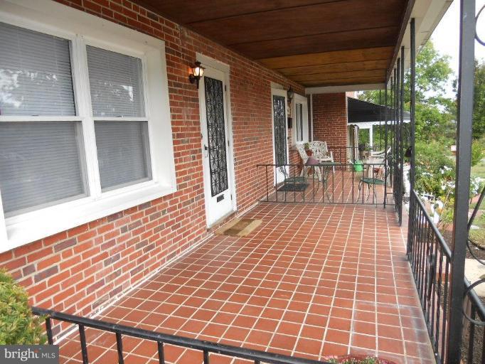 844 Bradhurst Road Baltimore, MD 21212 - Photo 3 of 17 a view of a patio with table and chairs with wooden floor and fence