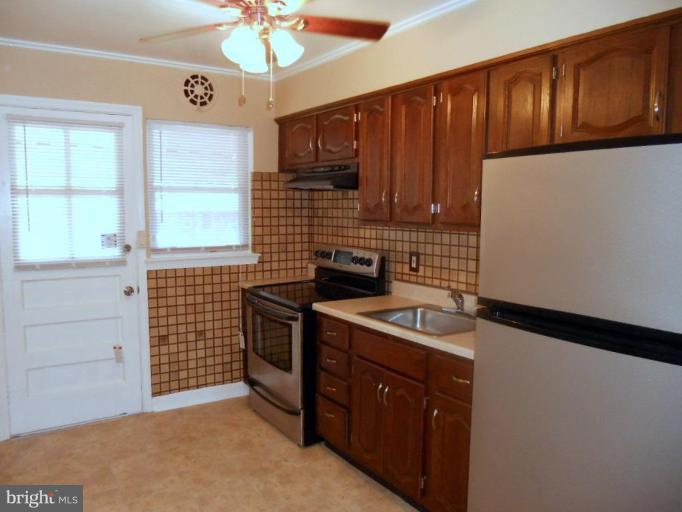 844 Bradhurst Road Baltimore, MD 21212 - Photo 7 of 17 a kitchen with a sink cabinets and window