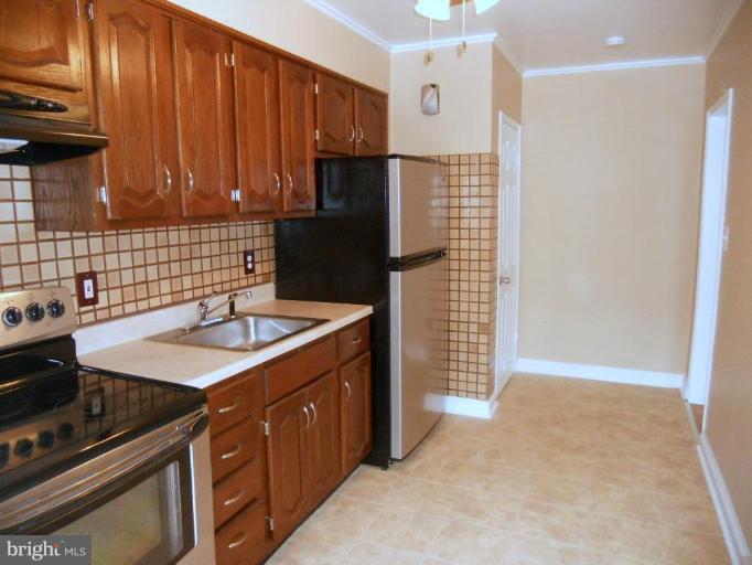844 Bradhurst Road Baltimore, MD 21212 - Photo 8 of 17 a kitchen with a sink stove and cabinets