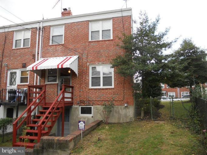 844 Bradhurst Road Baltimore, MD 21212 - Photo 9 of 17 a front view of a house with a yard