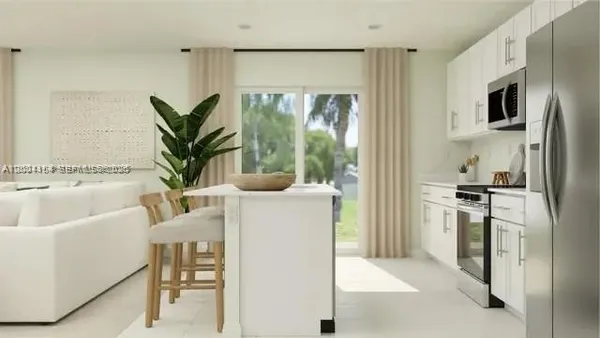 a living room with stainless steel appliances granite countertop furniture and a fireplace