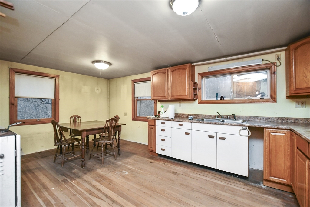 56 Pine Hill Road Orange, MA 01364 - Photo 14 of 30 a kitchen with granite countertop a sink cabinets and wooden floor