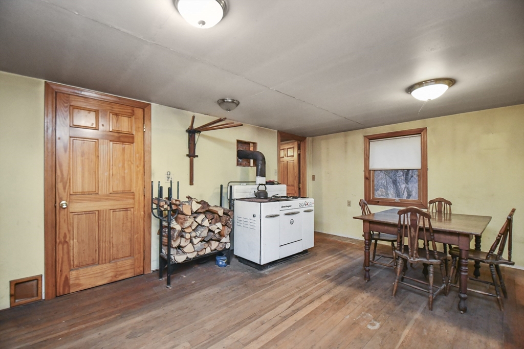 56 Pine Hill Road Orange, MA 01364 - Photo 16 of 30 a kitchen with a wooden table and chairs