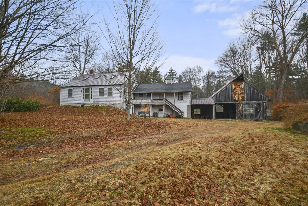 56 Pine Hill Road Orange, MA 01364 - Photo 2 of 30 a front view of a house with a yard and garage