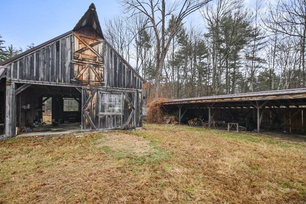56 Pine Hill Road Orange, MA 01364 - Photo 24 of 30 a view of a house with a yard and wooden fence