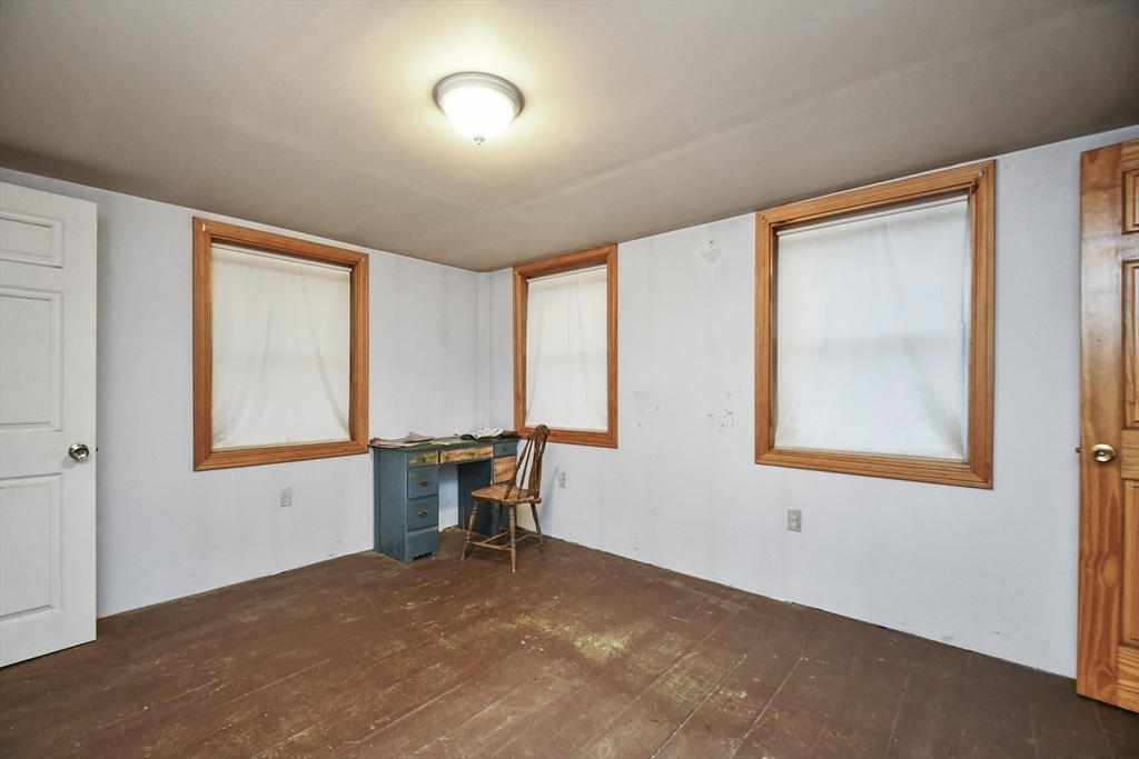 56 Pine Hill Road Orange, MA 01364 - Photo 10 of 30 a view of a workspace with furniture and a window
