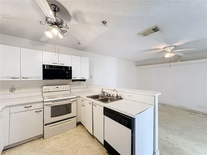 a kitchen with a sink stove and microwave