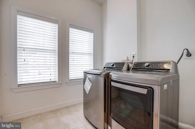 a spacious bedroom with a bed and a lamp