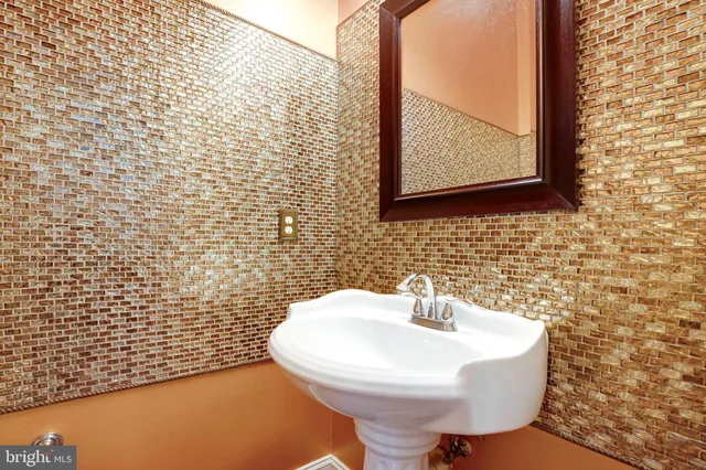 a view of a hallway with wooden floor and windows
