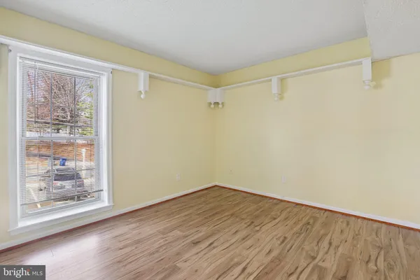 a view of a room with wooden floor and a window