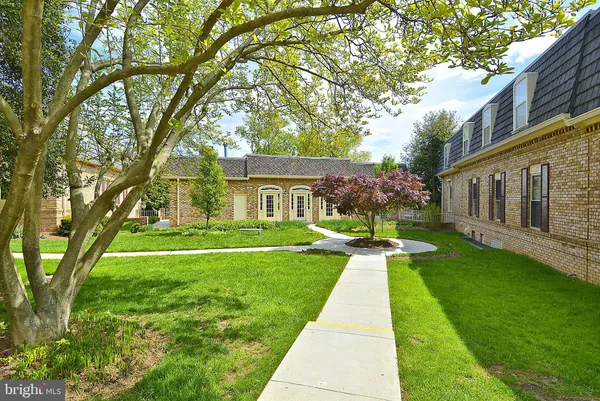 a front view of a house with yard and green space
