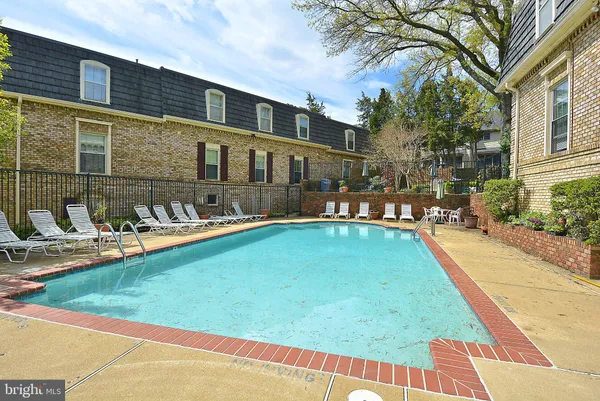 a swimming pool with outdoor seating and yard